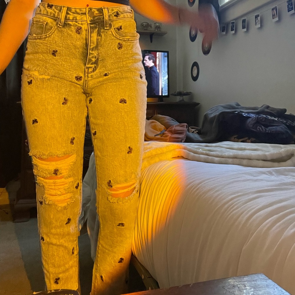 White washed ripped jeans with yellow butterfly’s from material girl.
